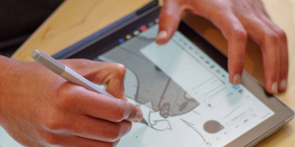 Hands sketching on tablet