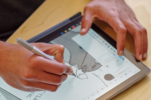 Hands sketching on tablet
