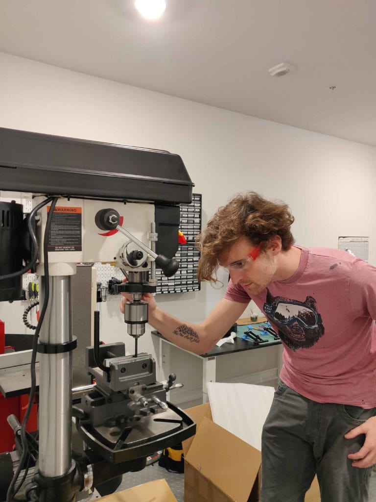 Thompson working with the drill press