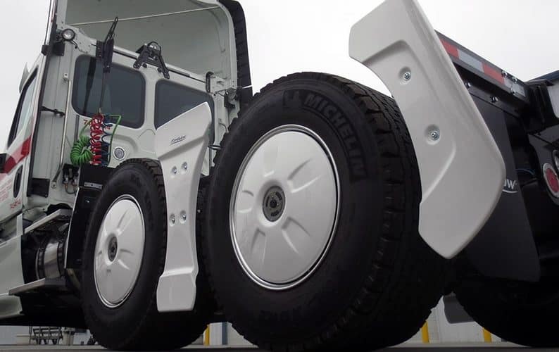 Flowbelow aerodynamic fairing kit on a white semi truck