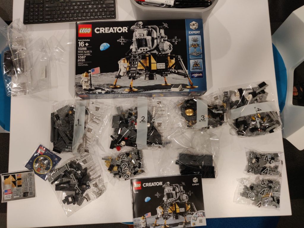 Lego lunar lander parts laid out in bags